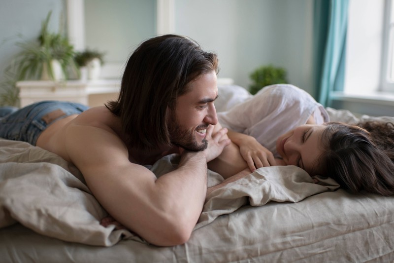 A woman compliments her boyfriend for his charming smile.