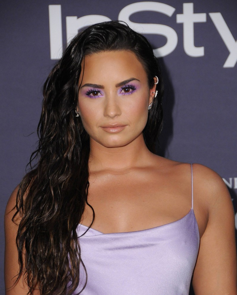 Demi Lovato rocks a purple eye makeup look.