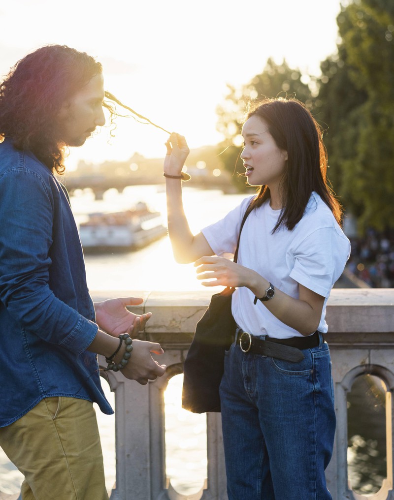 A young woman is annoyed by her boyfriend's hair.