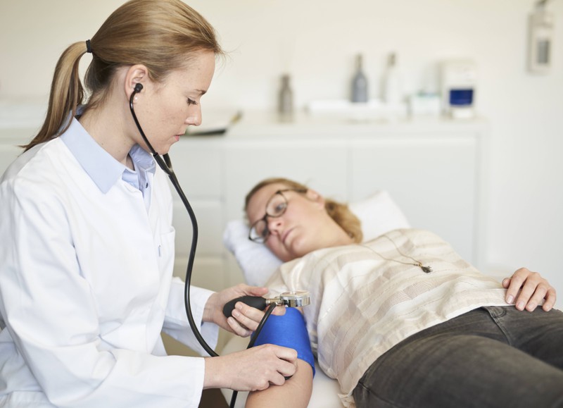 A doctor examines her patient.