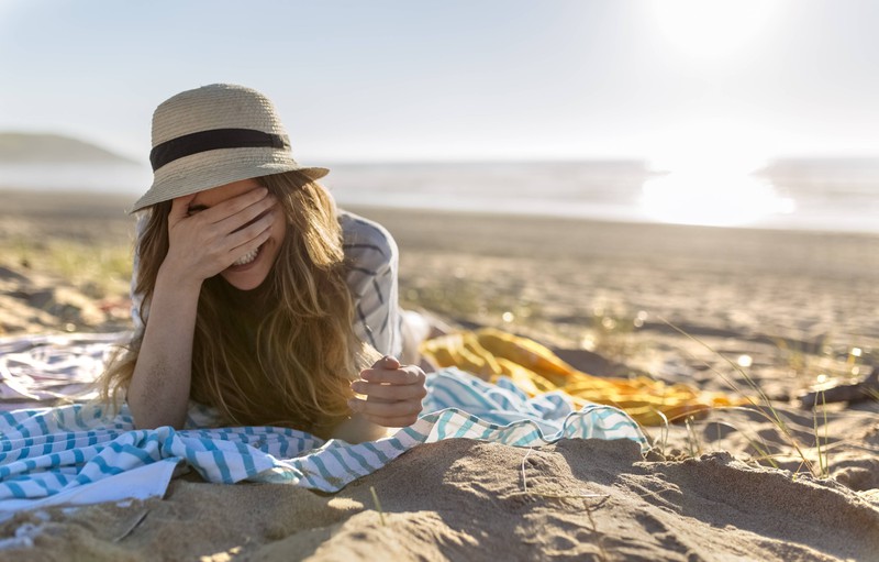 A woman is on vacation and embarrassed by a picture she sent to her parents.