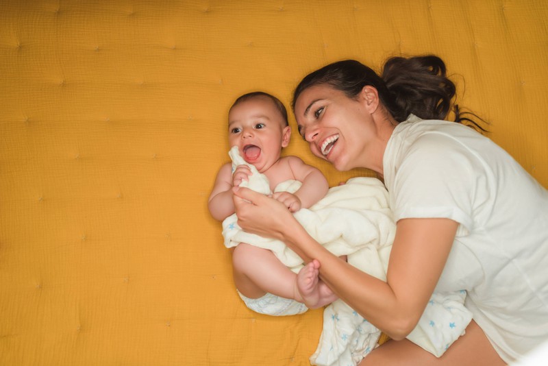 Happy mother is cuddling with her baby.