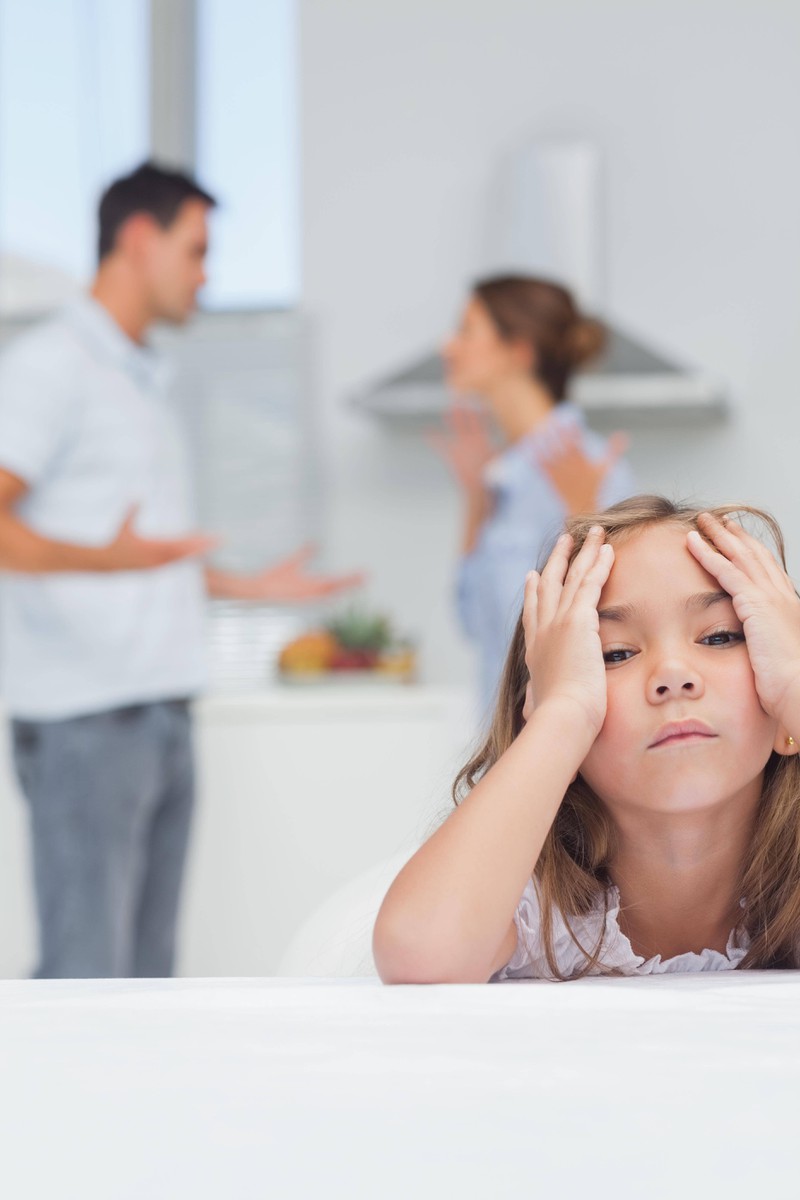 The girl is sad because her parents are fighting.