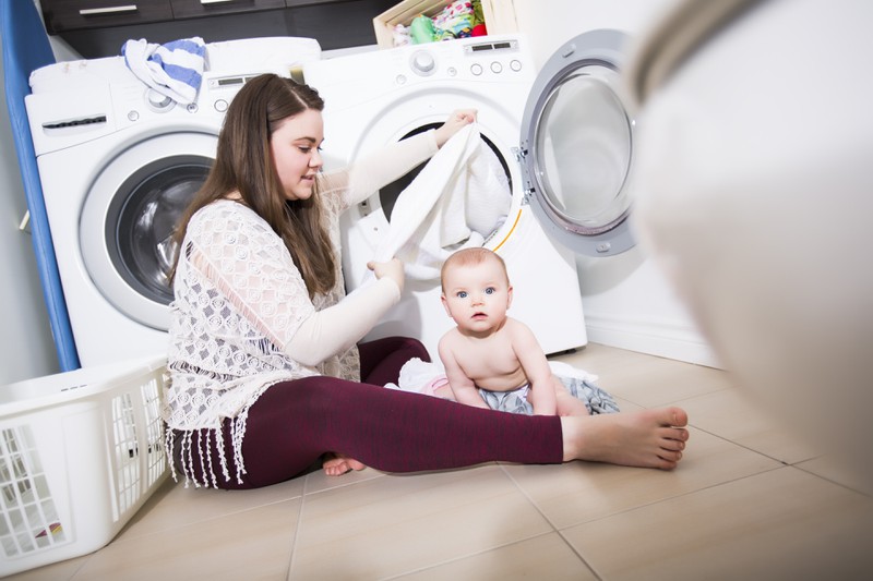 The babysitter did her own laundry at the family's house.