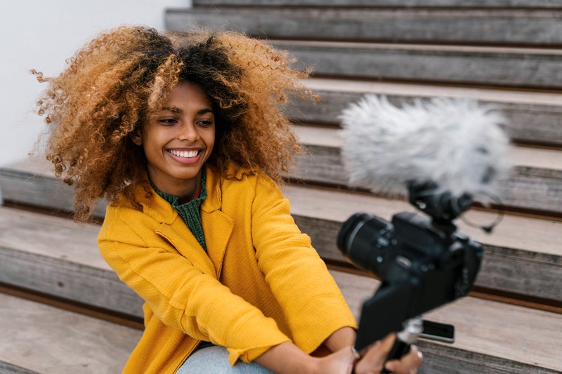 A woman vlogs instead of spending time with her boyfriend.