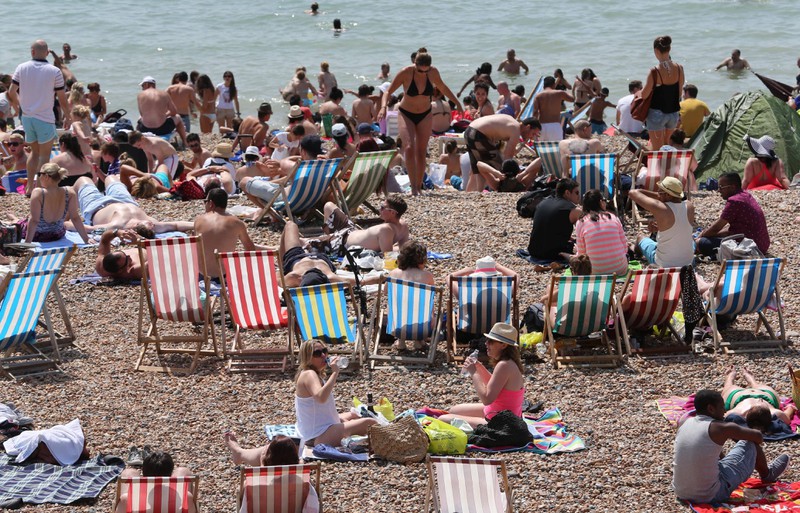 People are trying to escape the heat by going to the beach.