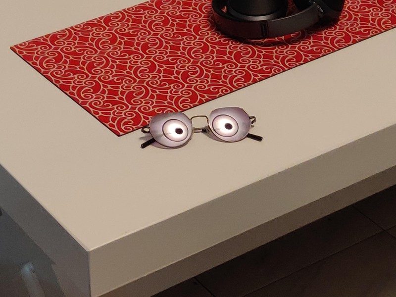 The glasses reflect the light, but it looks like they have eyes.