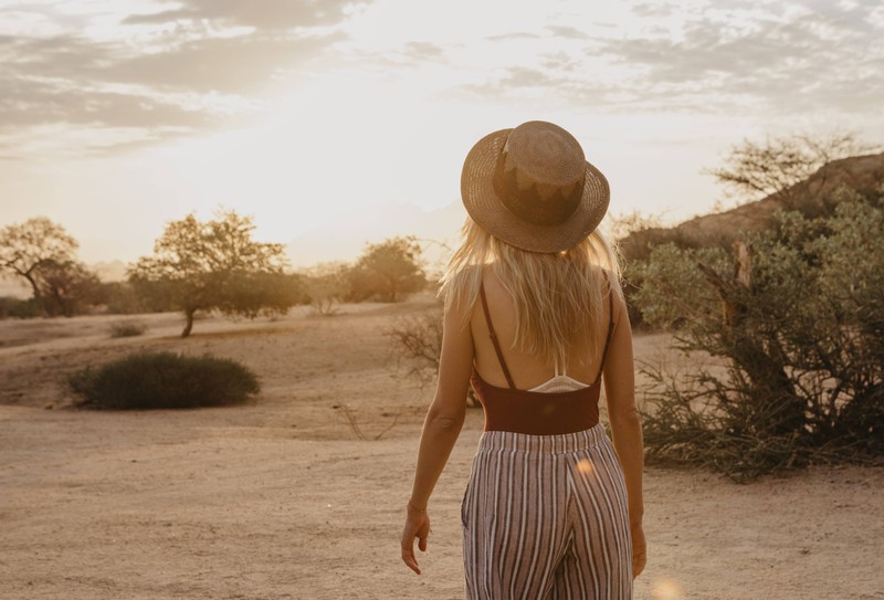 A woman wears a bare back with a bra