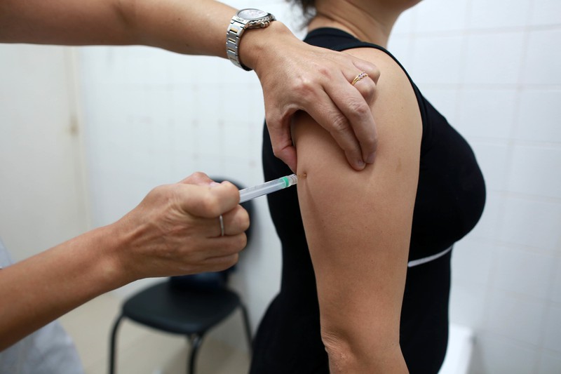 A woman is getting a vaccine.