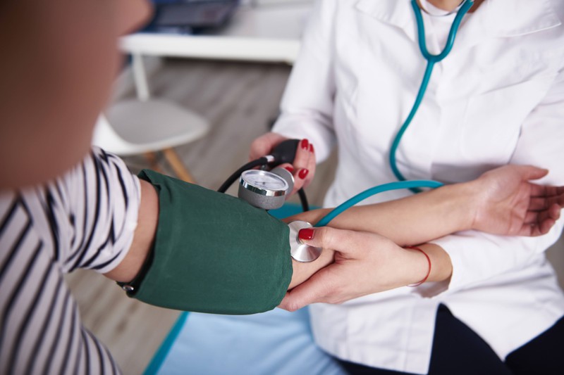 Doctor measures the blood pressure of a patient
