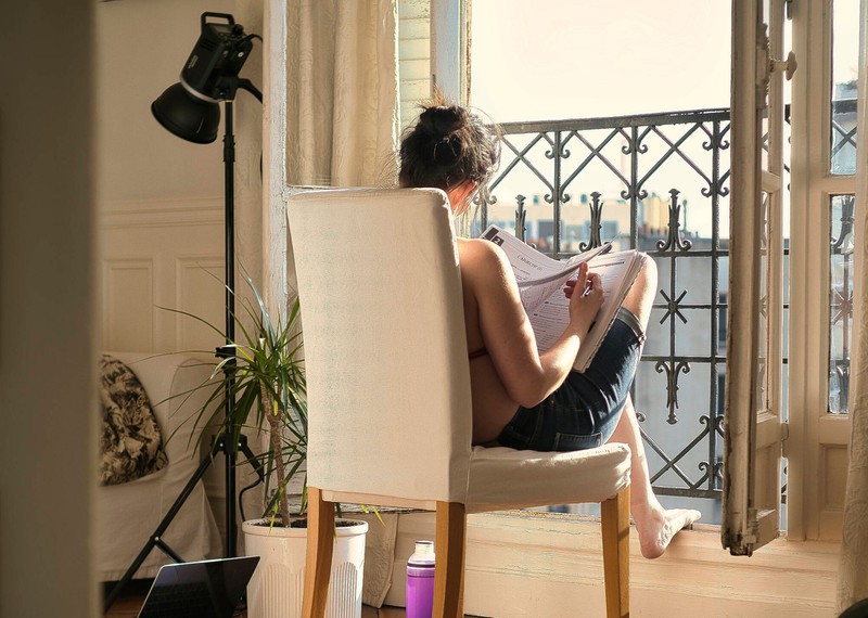 A woman at her window tries to cool her house