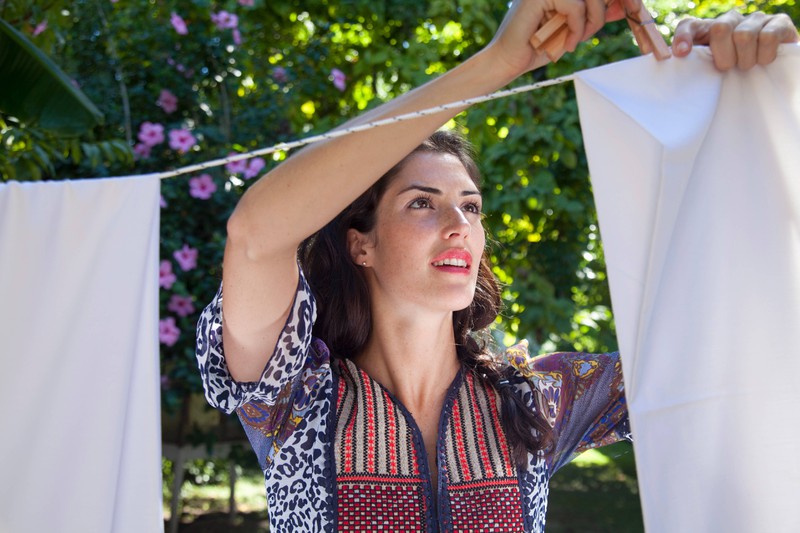 Woman hanging sheets