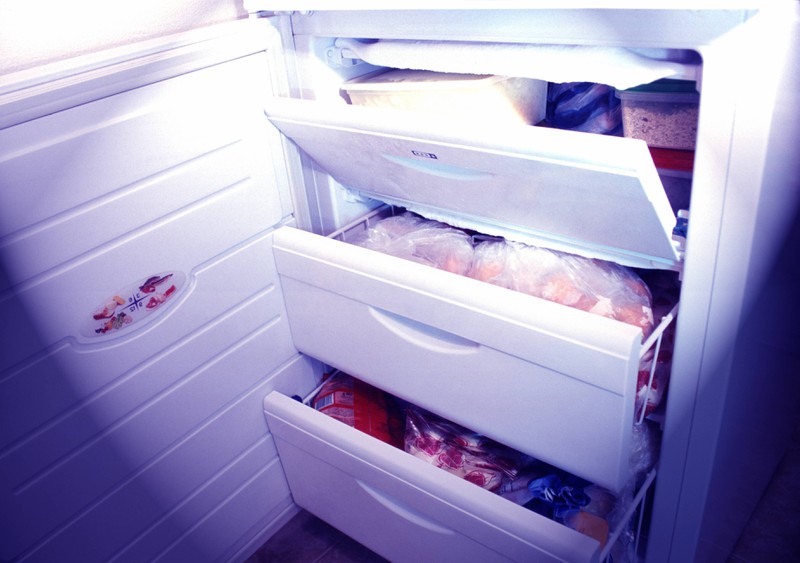 A freezer full of frozen food.