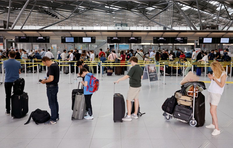 Many people are waiting at the airport to check their luggage